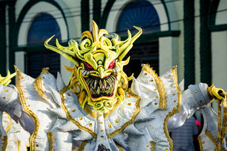 Concepcion De La Vega, DOMINICAN REPUBLIC - FEBRUARY 09, 2020: closeup man in sparkling mask poses for photo on city street at dominican carnival on February 9 in Concepcion De La Vegaのeditorial素材