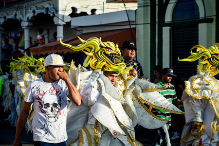 Concepcion De La Vega, DOMINICAN REPUBLIC - FEBRUARY 09, 2020: group of people in brilliant costumes...