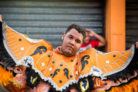 Concepcion De La Vega, DOMINICAN REPUBLIC - FEBRUARY 11, 2019: closeup portrait of young man in motley costume on city street at dominican carnival on February 11 in Concepcion De La Vegaのeditorial素材