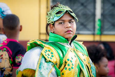 Concepcion De La Vega, DOMINICAN REPUBLIC - FEBRUARY 09, 2020: closeup young girl in green glossy costume pass by city street at dominican carnival on February 9 in Concepcion De La Vegaのeditorial素材