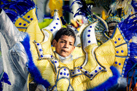 Concepcion De La Vega, DOMINICAN REPUBLIC - FEBRUARY 09, 2020: closeup young boy in blue glossy costume looks at camera at dominican carnival on February 9 in Concepcion De La Vegaのeditorial素材