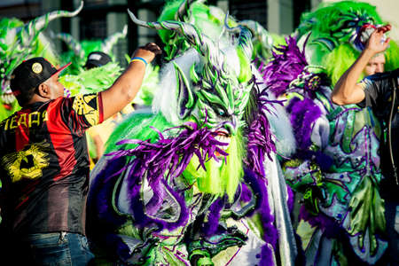 Concepcion De La Vega, DOMINICAN REPUBLIC - FEBRUARY 09, 2020: people in motley masquerade costumes pass on city street at dominican carnival on February 9 in Concepcion De La Vegaのeditorial素材