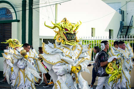 group of people in luminously costumes pass by city street at dominican carnivalのeditorial素材
