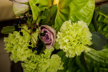 top view closeup beautiful handmade bouquet of purple roses and green flowers