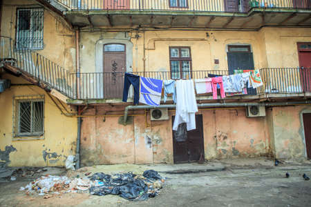 old inner courtyard with different clothes drying on balcony in historical part of Lviv city, Ukraineの写真素材