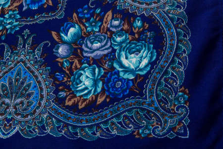 flat lay top view closeup part of bright blue rose and paisley floral pattern on dark blue cotton female shawlの写真素材