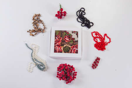 top view on white gift box with soft cotton scarf served with different bright accessories flat lay on light gray backgroundの写真素材