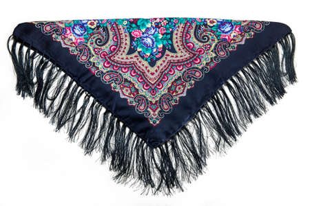 top view on folded black cotton scarf with fringe and colorful floral ornament with paisley print isolated on white backgroundの写真素材