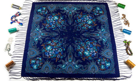 top view on blue cotton scarf with fringe, bright floral ornament, and different accessories flat lay on white backgroundの写真素材