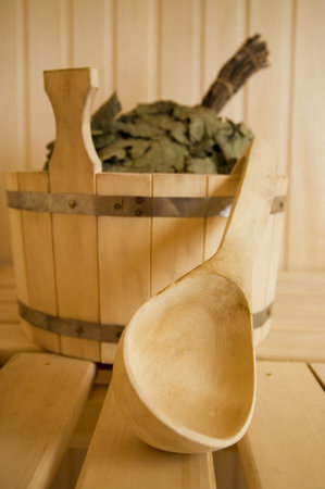 Wooden wash-tub with scoop in steam bath-roomの写真素材