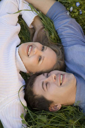 Young pair of sweethearts in the grass   の写真素材
