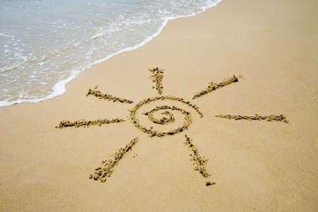 Sun pictured on the sand of coastline  の写真素材