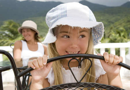 Girl and her mother in the backgroundの写真素材