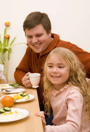 Father and his daughter have a breakfast  の写真素材