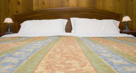 Wide bed with two table lamps  の写真素材
