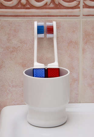 Two tooth brushes in the plastic cup  の写真素材