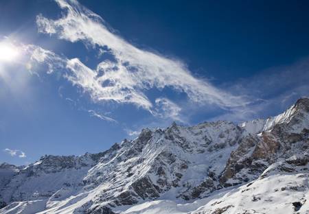 Fantastical clouds over snowy mountains  の写真素材