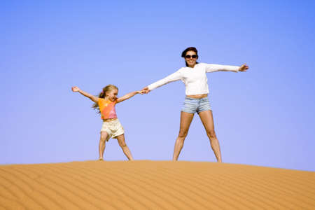 Mother with daughter against a background of the sky  の写真素材