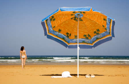 Girl is going to take a swim in the sea  の写真素材
