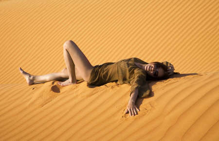 Young woman lying in the dune  の写真素材