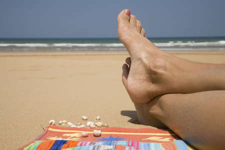 Coastline view with spreaded woman's legs  の写真素材