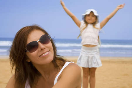 Portrait of mother with daughter on the beach  の写真素材