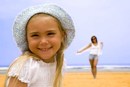 Portrait of daughter with mother on the beach  の写真素材