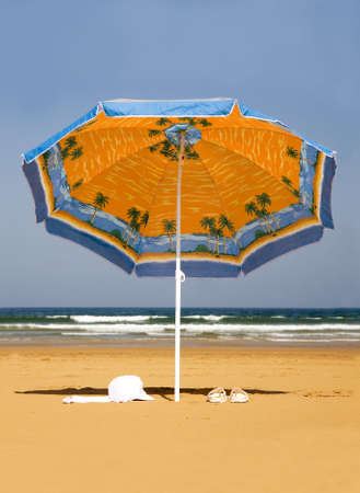 Lonely parasol on the beach  の写真素材