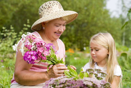Grandma and her grandchild have a rest in the park  の写真素材