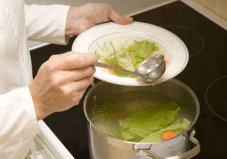 Woman is making vegetable soup  の写真素材