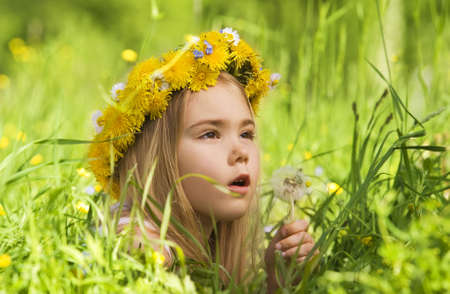 Portrait of a little girl in the grass   の写真素材