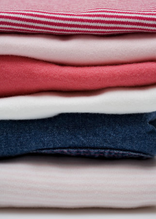 Stack of color clothes stored in rows  の写真素材