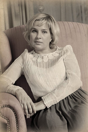 Elegantly young woman. Image is processed with a sepia tone and a texture has been in added to image