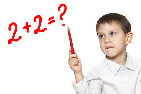Little boy is looking for a solution, holding pencil in his hand
