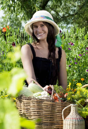 Caucasian young woman in a hat in the gardenの写真素材