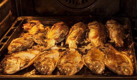 Fried fish crucian on a baking tray