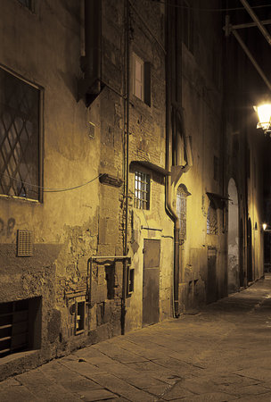 Ancient alleyway in Pisa  Tuscany, Italy  at nightの写真素材
