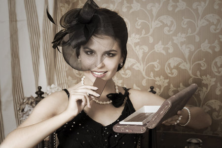 Portrait of beauty young woman with chocolate  Emulations of vintage style photography