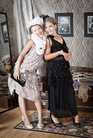 Vintage style portrait of little girls in old-fashion dressの写真素材