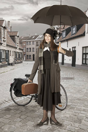 Young woman with umbrella outdoors. Mary Poppins versionの写真素材