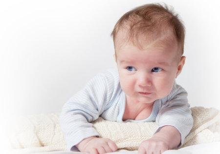 Portrait of a newborn baby lying on his tummy