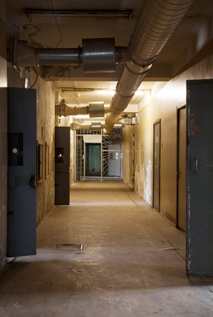 Corridor in an abandoned Penitentiary with open doors of prison cells
