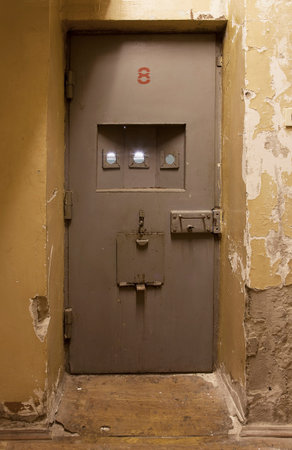 Light coming in through jail cell door at an abandoned prison jail