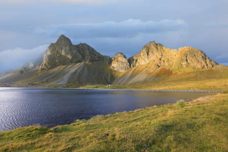 Amazing Icelandic landscape with mountains, bay, sky and cloudsの写真素材