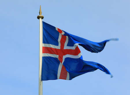 Iceland flag waving on the wind against a blue skyの写真素材