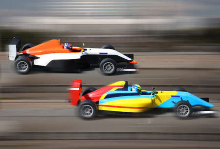 Formula 4.0 race cars racing at high speed on speed track with motion blur at sunny day 
の写真素材