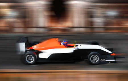 Formula 4.0 race car racing at high speed on speed track with motion blur の写真素材