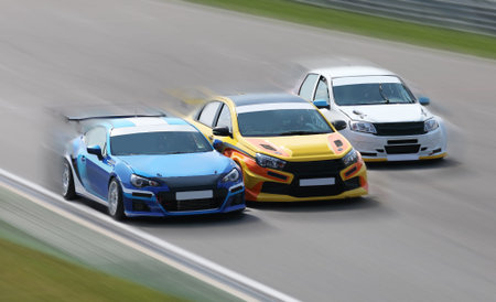 MOSCOW, RUSSIA -AUGUST 19:  Three  race cars racing at high speed on speed track with motion blur on a racing track in Moscow Raceway, Moscow on 19 August 2017, Russiaのeditorial素材
