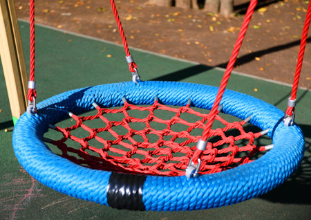 Empty swings in children playground closeupの写真素材