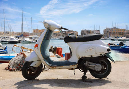 Old Italian scooter on the city pier in Syracuse city. Sicily, Italyの写真素材